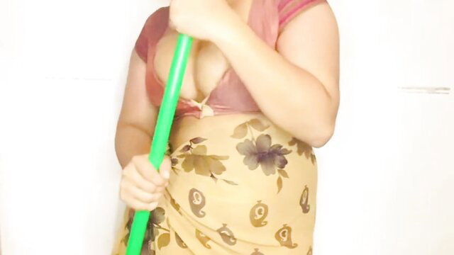 Sinhala maid in floral saree holds mop, deep cleavage tease