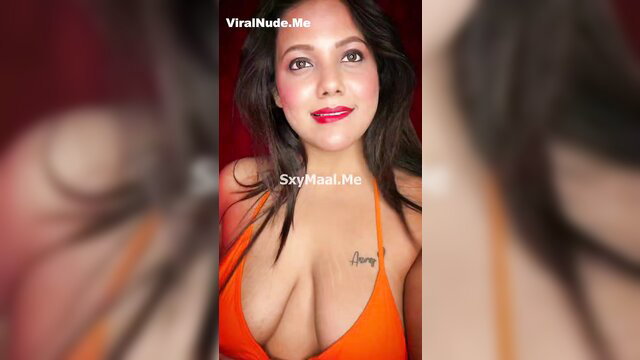 Barsha Sen sultry bikini dance, deep cleavage in orange dress