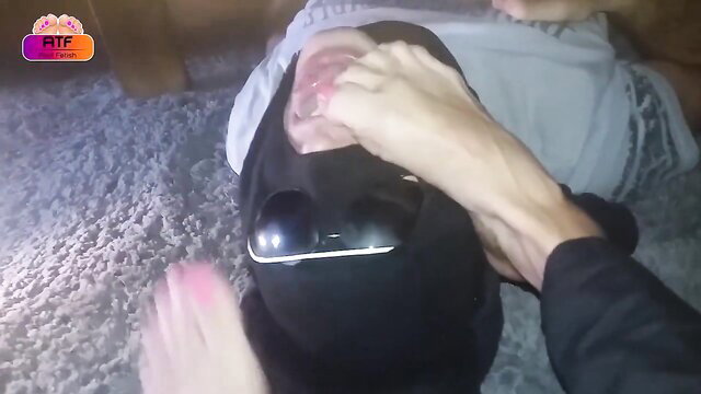 Woman's feet being tickled under a table