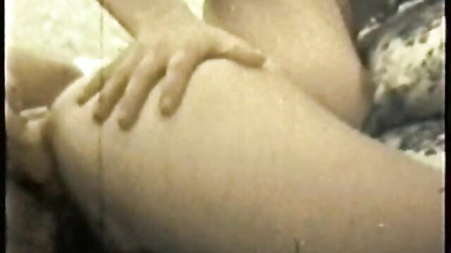 Retro porn closeup of hand gripping nude thigh in vintage XXX scene