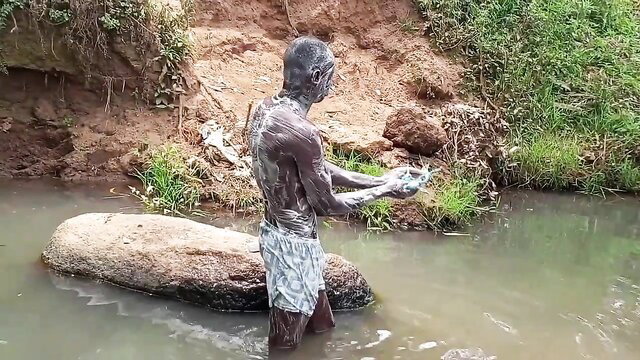 Hot Kenyan man bathing nude in river, soapy body, amateur outdoor