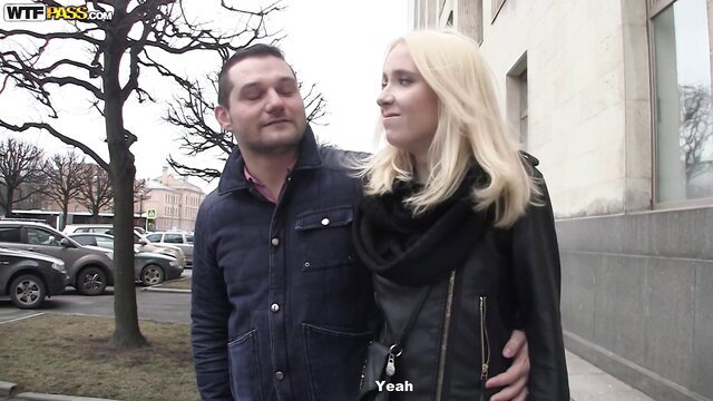Isabel Ice and man smiling outdoors in leather jacket and scarf