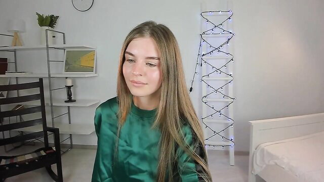 Blonde teen in shiny green dress flashes body in bedroom tease