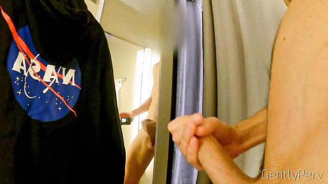 Naked man stroking cock in mirror reflection, NASA hoodie nearby