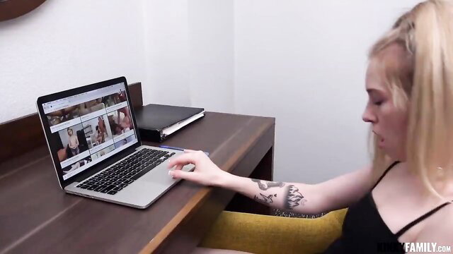 Madi Collins blonde tattooed stepdaughter on laptop in black top