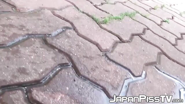 Embarrassed Japanese babe caught peeing on outdoor pavers