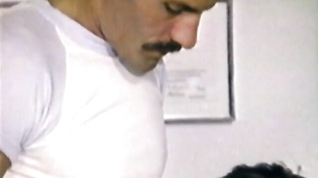 man with mustache bending over