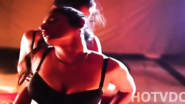 Two busty Indian women in black lingerie embracing passionately