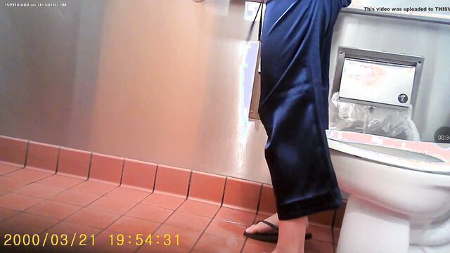 Woman in silk pajamas pisses standing in toilet, sexy feet closeup