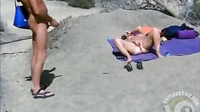 Nude mature woman sunbathing on beach watched by masturbating guy