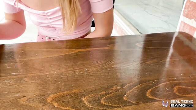 Della Cate in pink off-shoulder top teasing at table