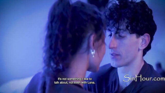 Black woman in ponytail whispers intimately to curly-haired man in tense talk