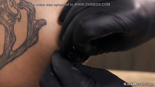 Goth petite girl with tattoo gets nipple pierced by gloved dom