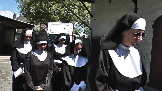 Nuns walking in a line outdoors