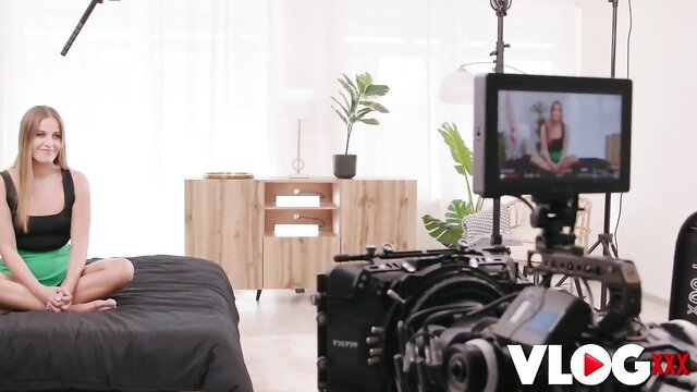 Eveline Dellai in sexy green skirt on bed vlog setup