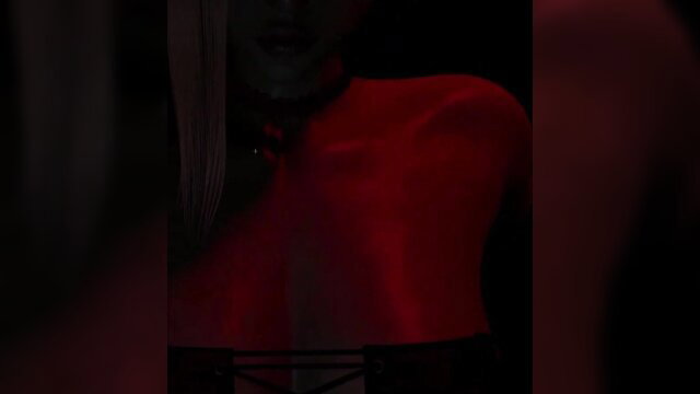 Blonde MILF in red shiny top and black straps, seductive pose