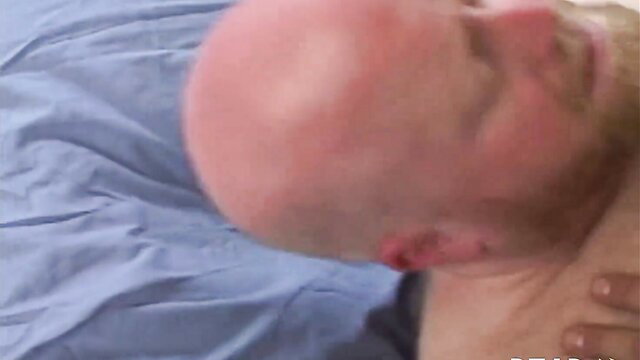 Bald bearded man neck gripped in intense closeup at Love Trans Sex