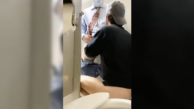Suited daddy cruising bathroom blowjob with masked guy on toilet