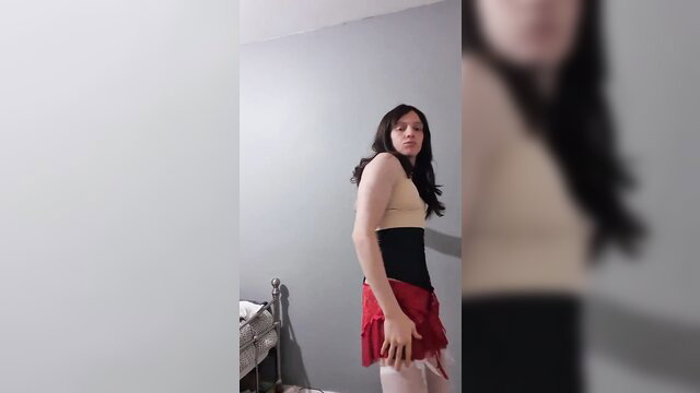 Shemale in corset, red skirt and stockings does big ass strip tease