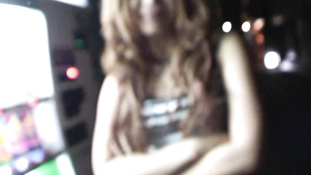 Airi Mashiro arms crossed in dim club, sexy top, wavy hair