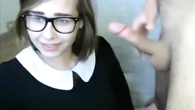 Catholic schoolgirl with glasses smiles as guy teases her lips with cock on cam