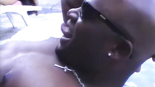 Bald Black man in shades yelling in retro bi-racial pool sex scene