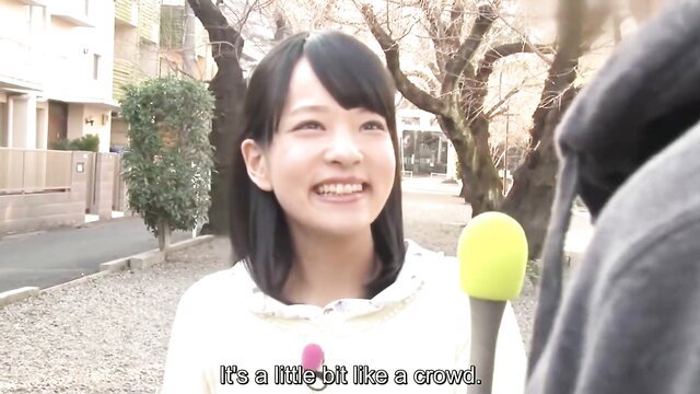 Mikako Abe smiles at mic in casual hoodie on street JAV interview