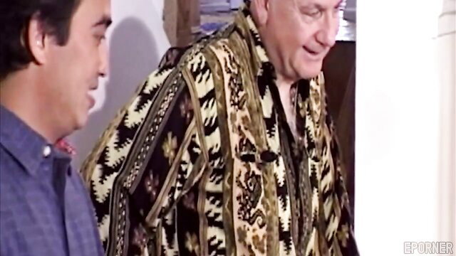 Married Asian woman smiling with older white man in loud shirt, cuckold setup