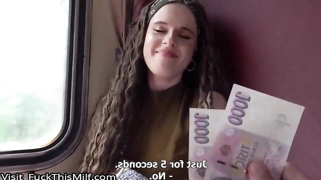 Curly-haired brunette MILF smiling with cash on train in hot thumbnail