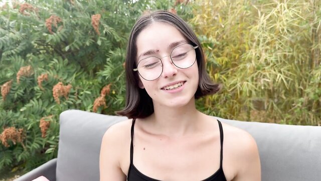 Penelope 19yo in black tank top smiles teasingly outdoors
