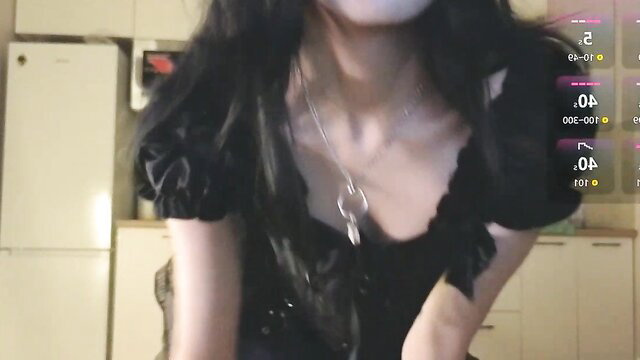 Asian camgirl in black off-shoulder top, cleavage tease, live stream