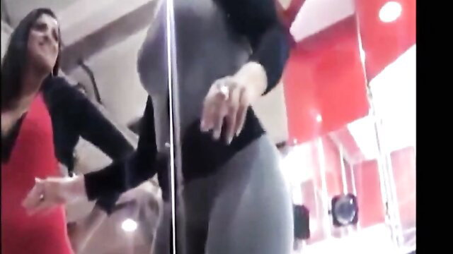 Stacked brunettes in tight suits shake big booties in gym mirror