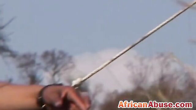 Chubby ebony slave tied with rope, hand spanked by master