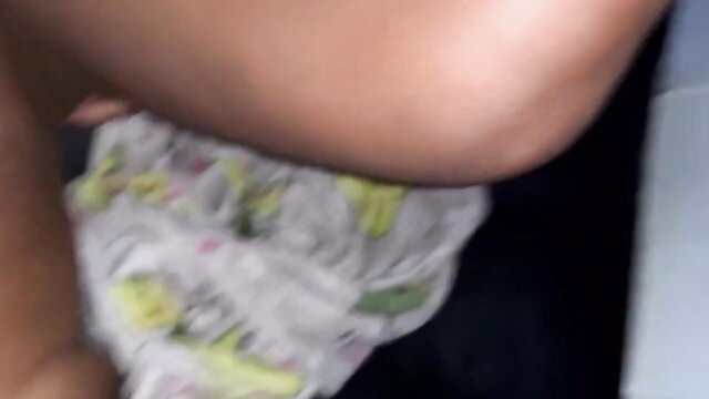 Closeup of wet pussy with yellow stains in used diaper, dark skin