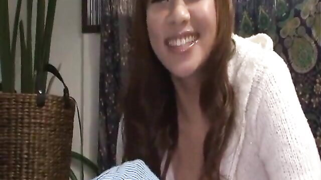 Asian JAV babe in hoodie smiles with deep cleavage tease