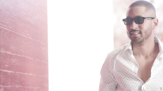 Handsome Black man in shades and open shirt, Scarlit Scandal real estate agent