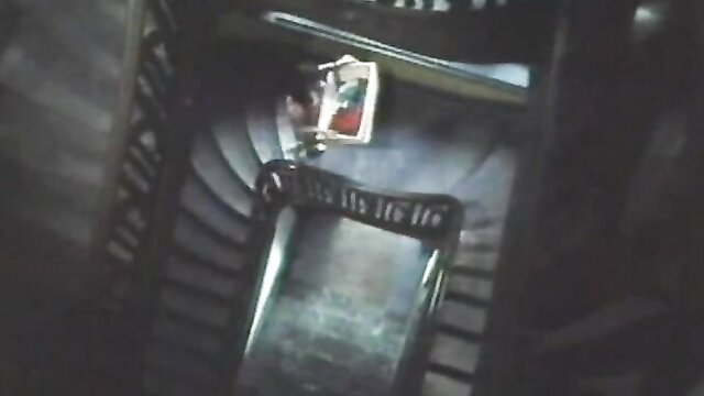 Vintage brunette hanging on spiral staircase in sexy dress, legs spread