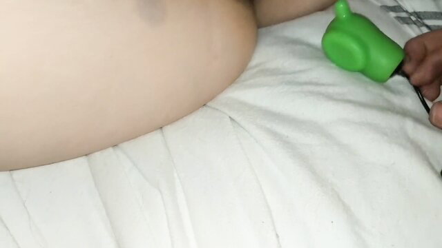 Pregnant woman restrained in straightjacket, green vibrator on belly