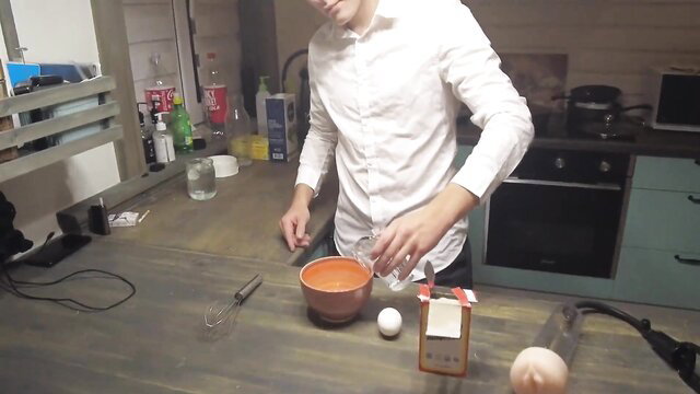 Man mixing eggs in kitchen with fleshlight penis enlargement demo