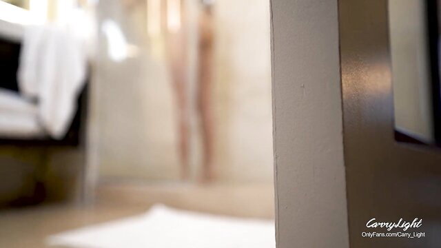 Blurry nude MILF silhouette in steamy shower, voyeur door view