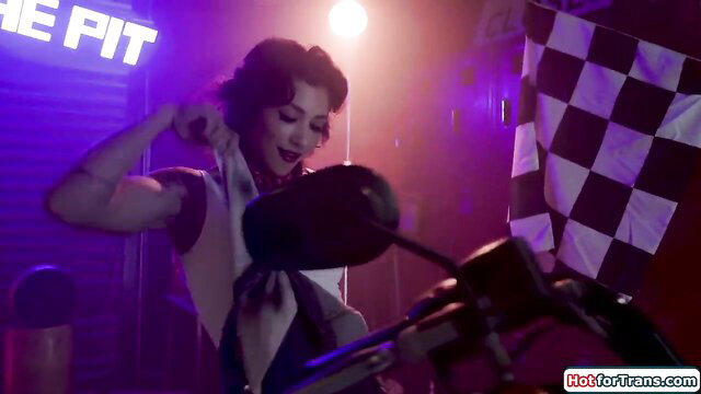 Jade Venus flexes muscular arms by motorcycle in hot garage