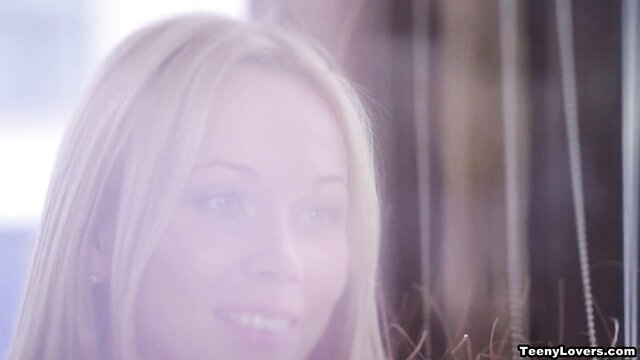 Blonde teen girlfriend smiling in soft-lit closeup