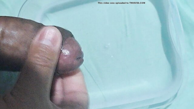 Aqua Cumshot: Black man handjobs thick cock into water dish