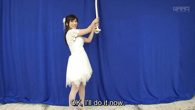 Miki Sunohara in white lace wedding dress holding rope striptease