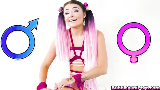 Pink-haired Asian babe in BDSM harness and wrist ties smiles playfully