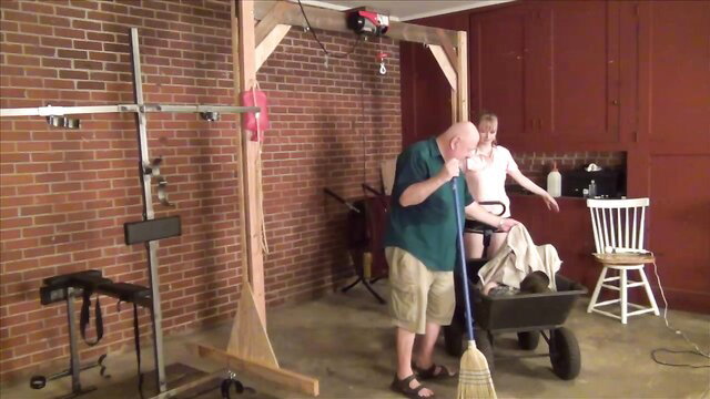 Hazel blindfolded in pony training, bound in wheelbarrow by dom