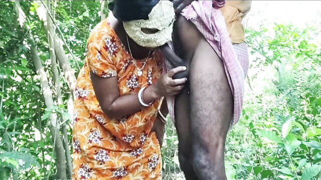 Desi village wife in mask kneels sucking husband's cock in forest