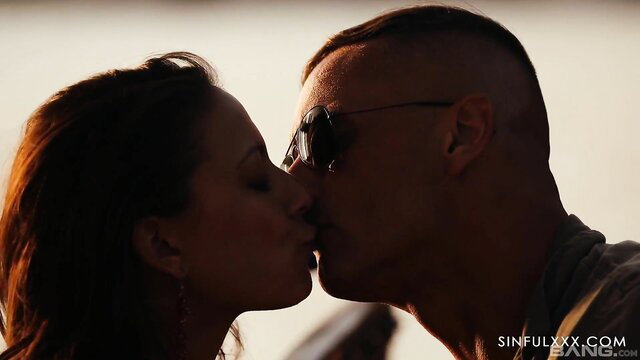 Anna Claire Clouds silhouette kiss with shaved head man in sunset glow