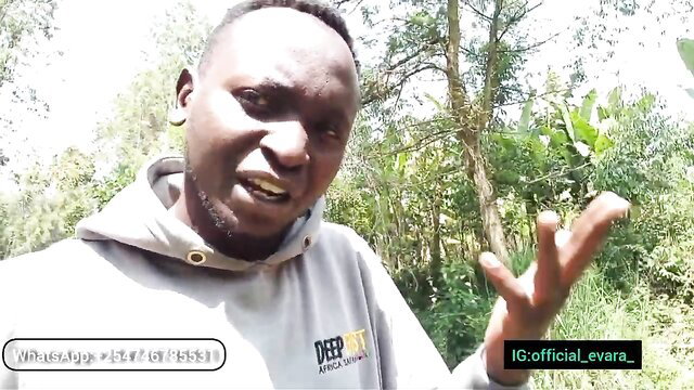 African YouTuber in hoodie flashing peace sign outdoors