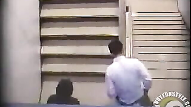 Man in white shirt chases woman up stairs in public amateur tease